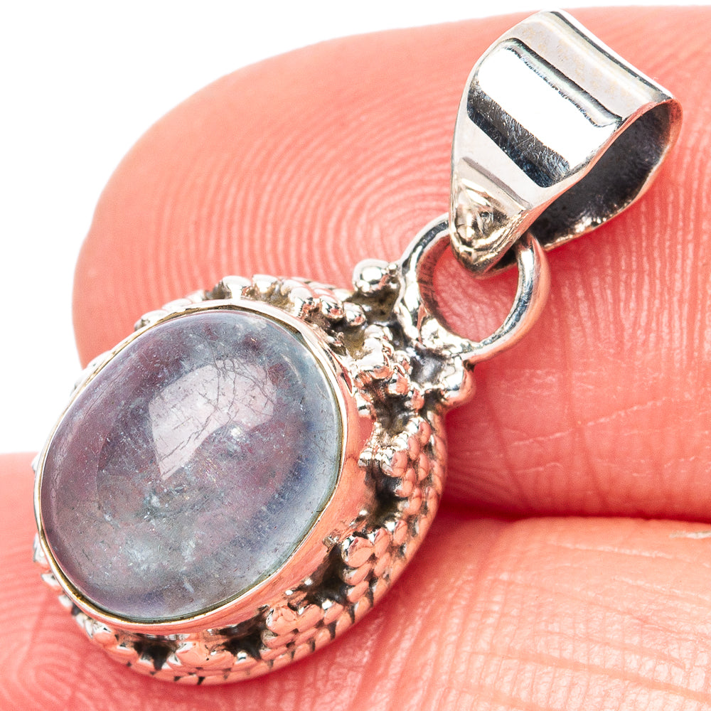 Sterling silver oval aquamarine pendant with ornate filigree bail and textured bezel