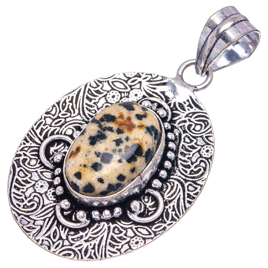 Dalmatian jasper pendant featuring an oval stone in a silver-tone engraved round setting, bail top