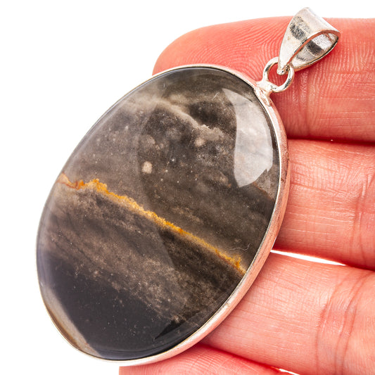 Oval galaxy jasper pendant close-up with speckled gray-brown stone and silver frame