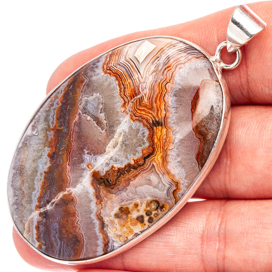 Silver-plated teardrop pendant with lace-like agate banding and top bail.