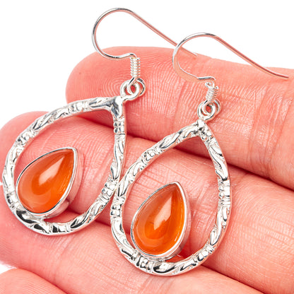 Teardrop carnelian earrings in silver with orange teardrop stones and dangling hooks
