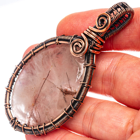 Quartz teardrop pendant with oxidized copper wire wrap and spiral bezel bail