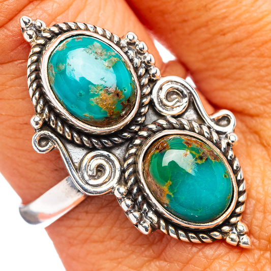 Turquoise oval cabochon silver ring with ornate scrollwork; two stones visible
