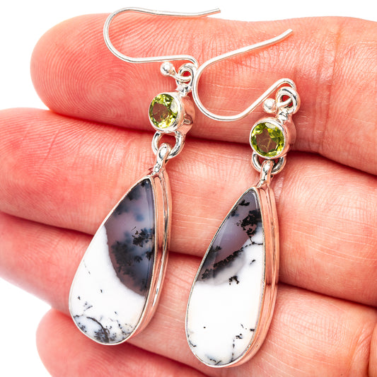 Sterling silver peridot and dendritic opal teardrop earrings with leaf-like stone detail.
