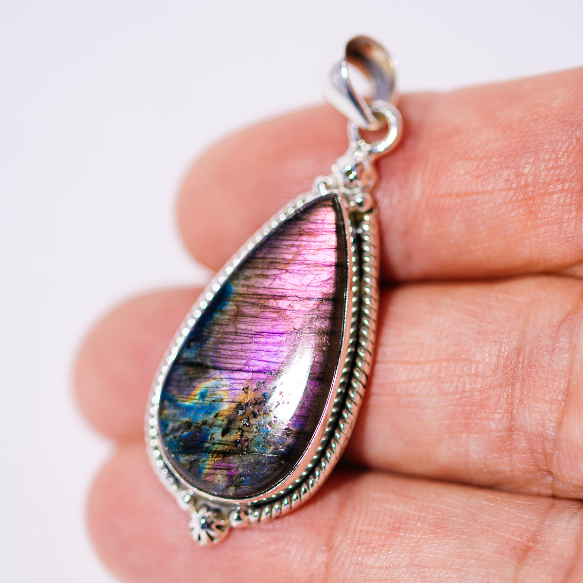 Purple labradorite teardrop pendant in a beaded sterling silver setting
