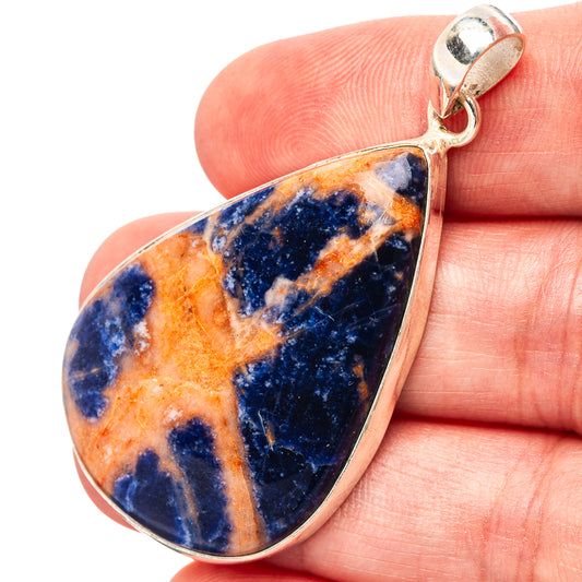 Sodalite teardrop pendant with .925 sterling silver bezel, blue and orange mottled stone