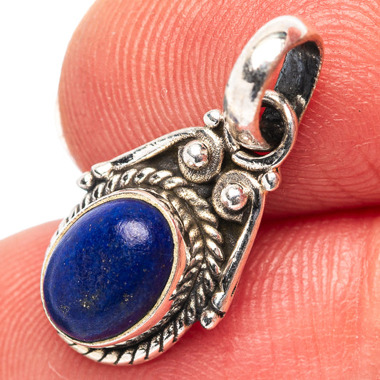Sterling silver lapis lazuli pendant with oval blue stone and ornate leaf filigree