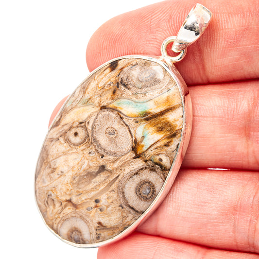 Sterling silver teardrop pendant with brown fossil stone and iridescent blue-gold veins
