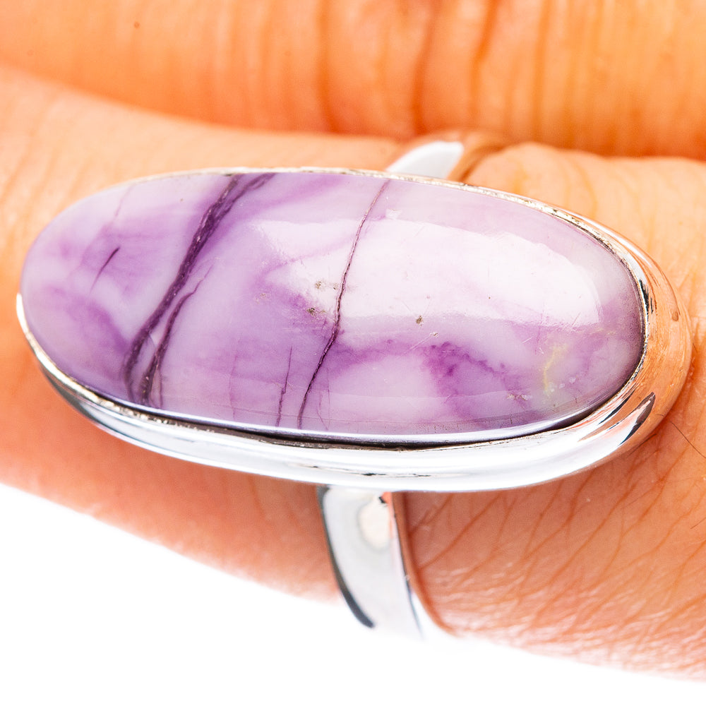 Sterling silver ring with oval purple stone cabochon, glossy polish and thin veining