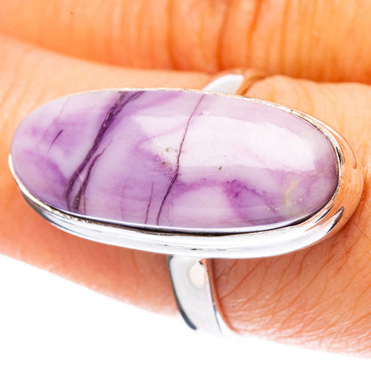 Sterling silver ring with oval purple stone cabochon, glossy polish and thin veining