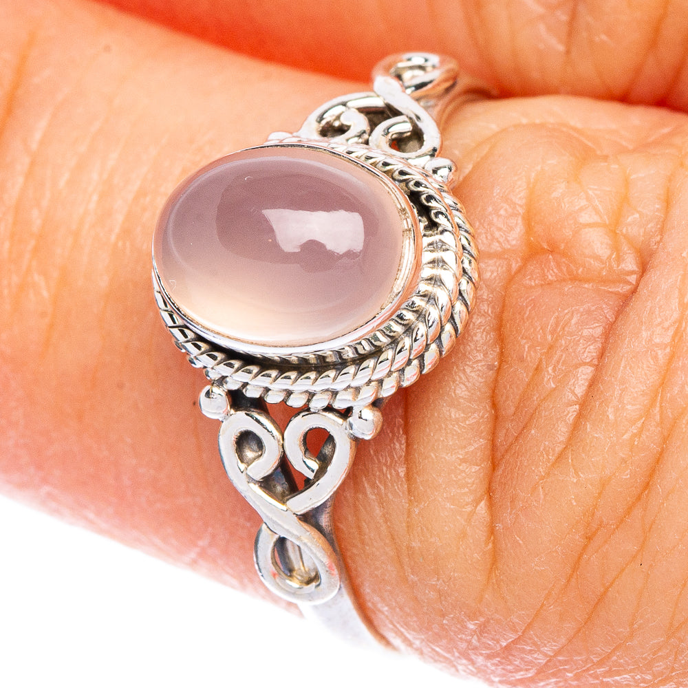 Sterling silver dainty ring with oval rose quartz and heart charm details