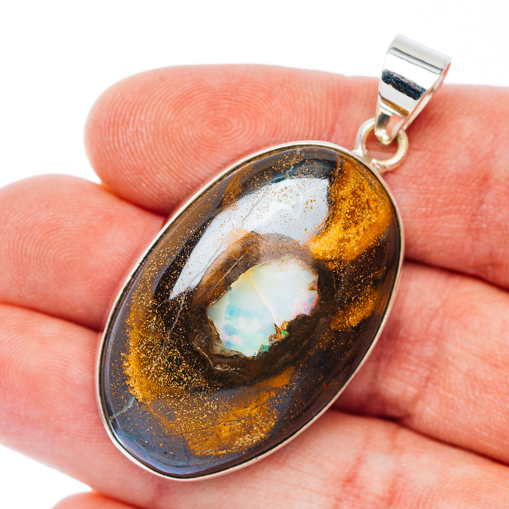 Sterling silver boulder opal pendant, teardrop bezel with golden and blue flashes