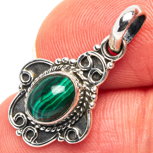 Sterling silver malachite pendant with oval green stone and ornate vintage-style frame