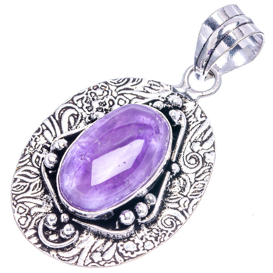 German silver amethyst pendant with oval purple stone, filigree border and top bail.