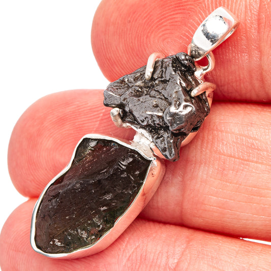 Sterling silver pendant close-up: rough black meteorite stone above dark backing and green gem