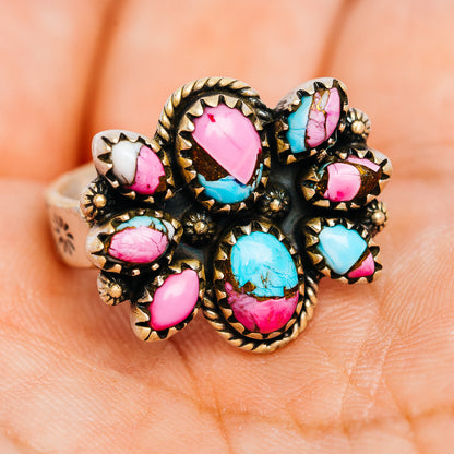 Southwestern turquoise and pink oval stone cluster ring with ornate .925 sterling silver band