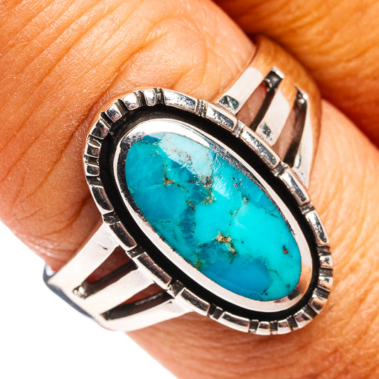 Oval turquoise stone sterling silver ring with etched bezel, openwork band detail