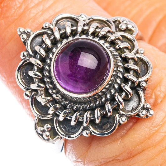 Amethyst cabochon sterling silver ring with purple oval center and detailed rope-like bezel