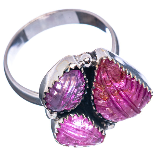 Sterling silver ring showing three carved oval purple gemstones and a black prong mount