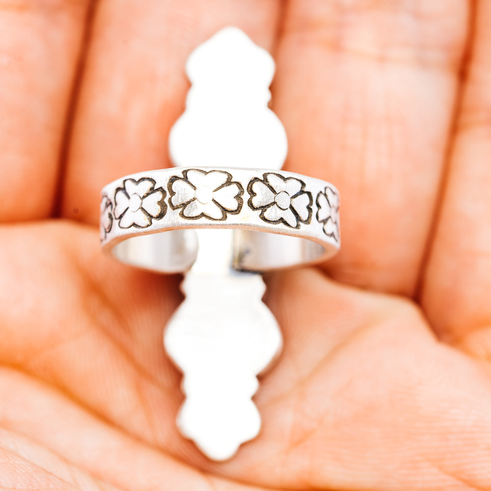 Sterling silver band ring with repeating flower cutout pattern