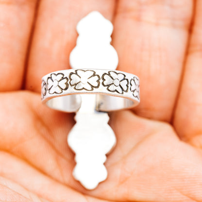 Sterling silver band ring with repeating flower cutout pattern