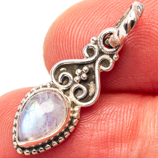 Oval rainbow moonstone pendant in 925 sterling silver with ornate filigree setting