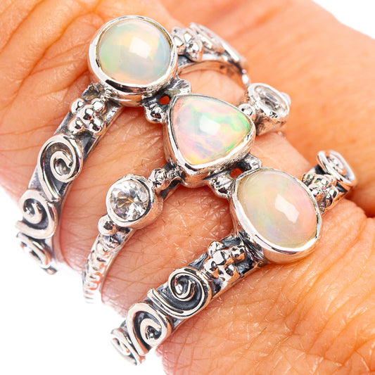 Sterling silver ring with oval opal-like stones and small round clear accents