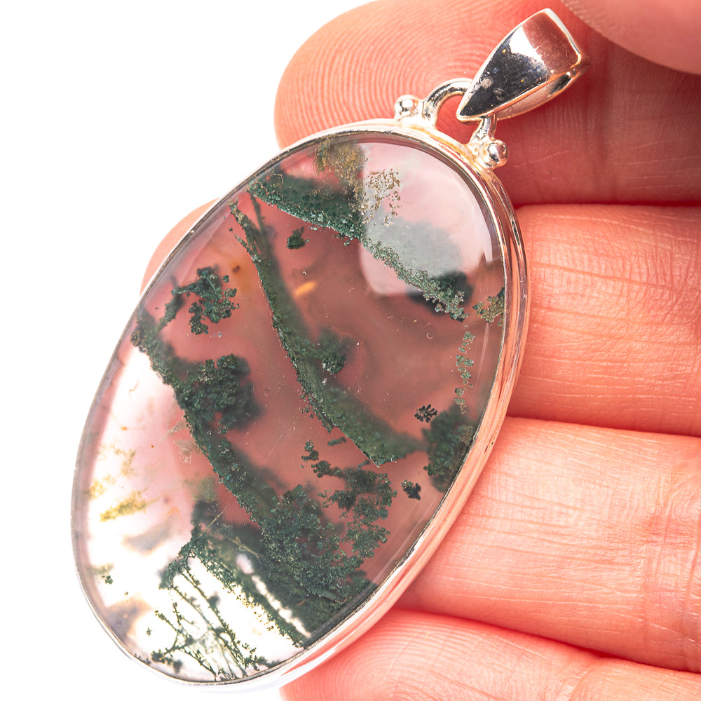 Oval sterling silver moss agate pendant with green dendrite inclusions, bezel