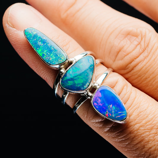 Opal doublet ring with three teardrop bezel-set stones in blue-green and purple, silver band