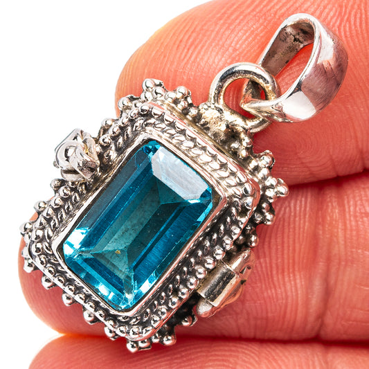 Sterling silver blue topaz pendant with ornate bezel and square gemstone, hinged bail