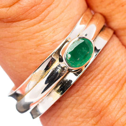 Sterling silver spinner ring with oval green emerald gemstone, bezel set