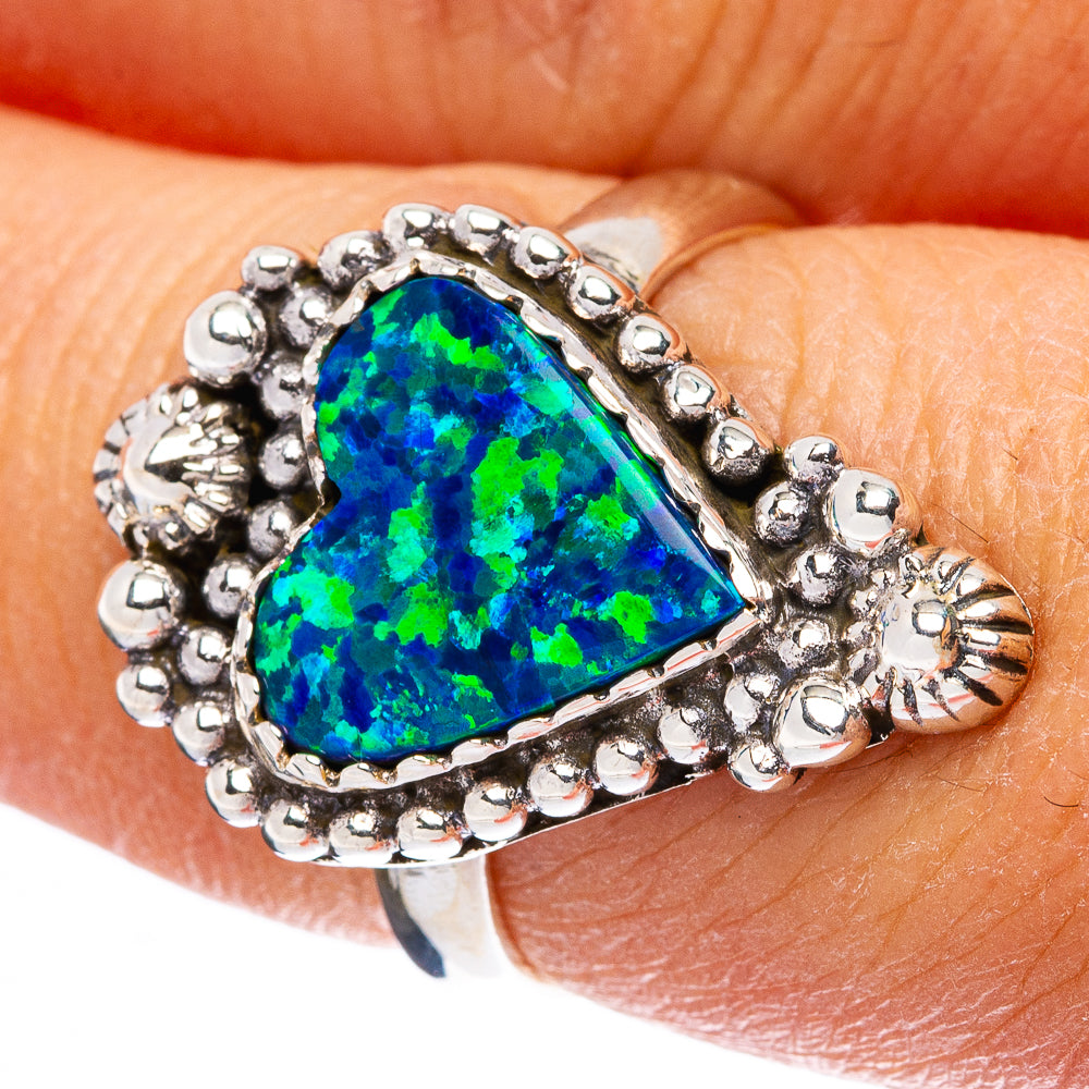 Sterling silver ring with oval synthetic opal in blue-green and beaded halo setting