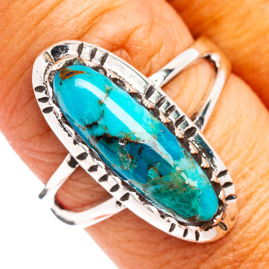 Sterling silver turquoise oval cabochon ring with decorative bezel and split shank
