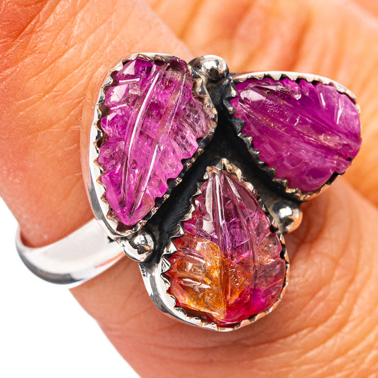 Sterling silver ring with three carved purple/orange gemstones and black prongs