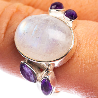 Sterling silver ring with round rainbow moonstone cabochon and three purple amethyst accents