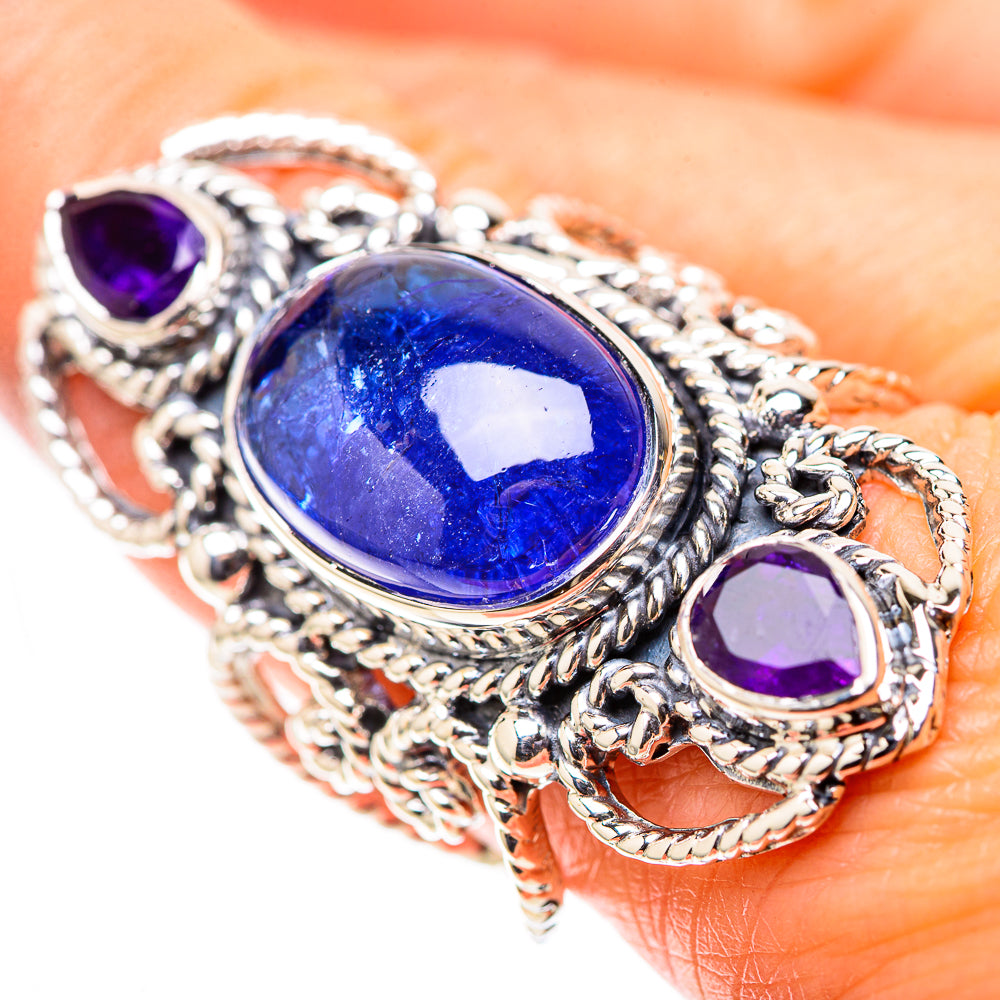 Ornate sterling silver ring with oval blue gemstone and two round purple stones