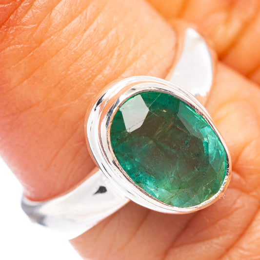 Sterling silver ring with oval faceted green emerald in bezel setting