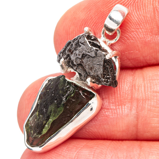 Sterling silver pendant with dark rough stone and green crystal in a silver bezel
