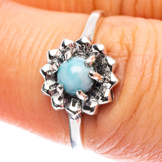 Sterling silver ring with oval light-blue stone and decorative prong setting