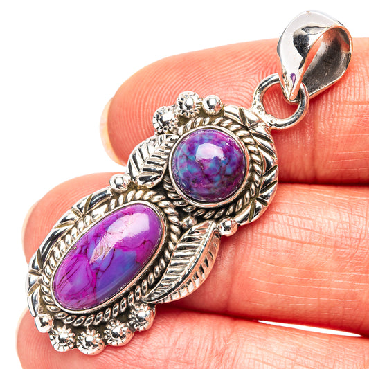 Sterling silver pendant with two oval purple cabochons and ornate bezel