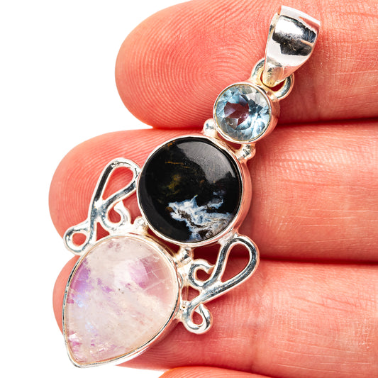 Sterling silver pendant with blue round gemstone, dark oval, and pearly pink stone