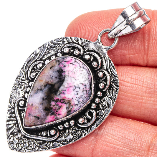 Dendritic opal pendant with pink-violet teardrop cabochon in ornate silver frame