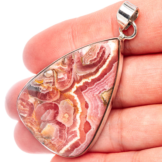 Rhodochrosite teardrop pendant, .925 sterling silver bail, close-up of pink stone