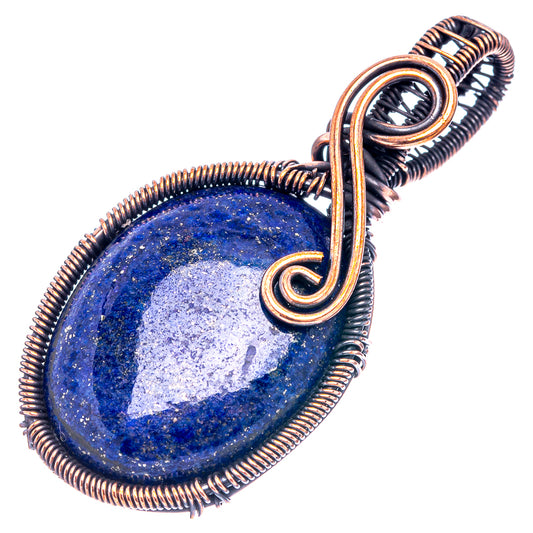 Lapis lazuli oval pendant wire-wrapped in oxidized copper, angled view of stone