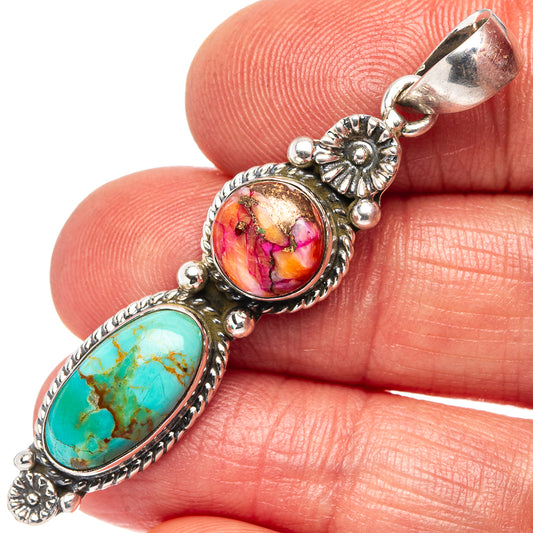 Sterling silver pendant close-up with turquoise oval stone and pink round cabochon