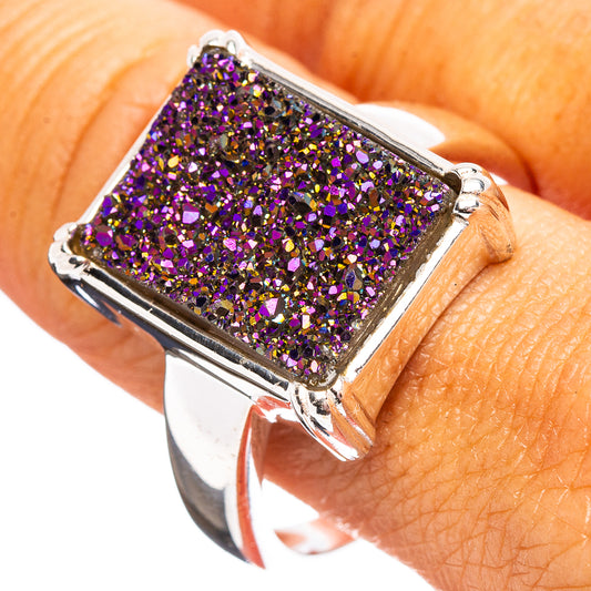 Square purple druzy stone ring with silver-toned prongs, on finger