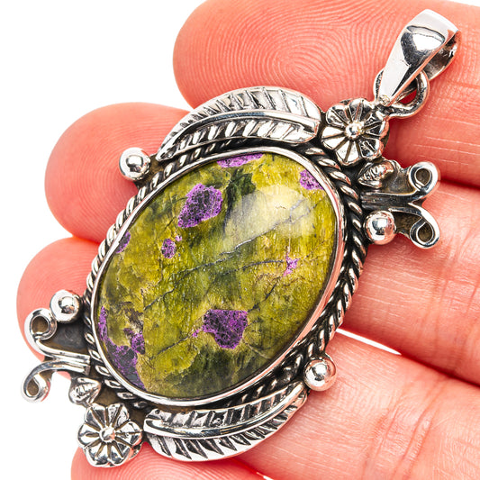 Sterling silver oval pendant with purple-and-yellow gemstone, ornate rope bezel