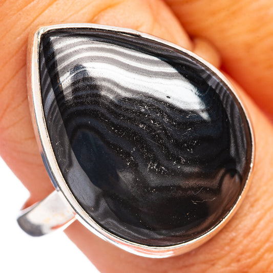 Sterling silver ring close-up, teardrop black psilomelane stone with striped swirls