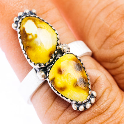 Adjustable sterling silver ring with two bezel-set oval yellow stones