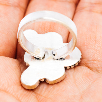 Sterling silver adjustable ring band with flower-shaped face
